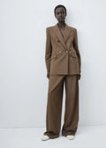 Structured women’s tailored jacket with a peak lapel shoulder design.