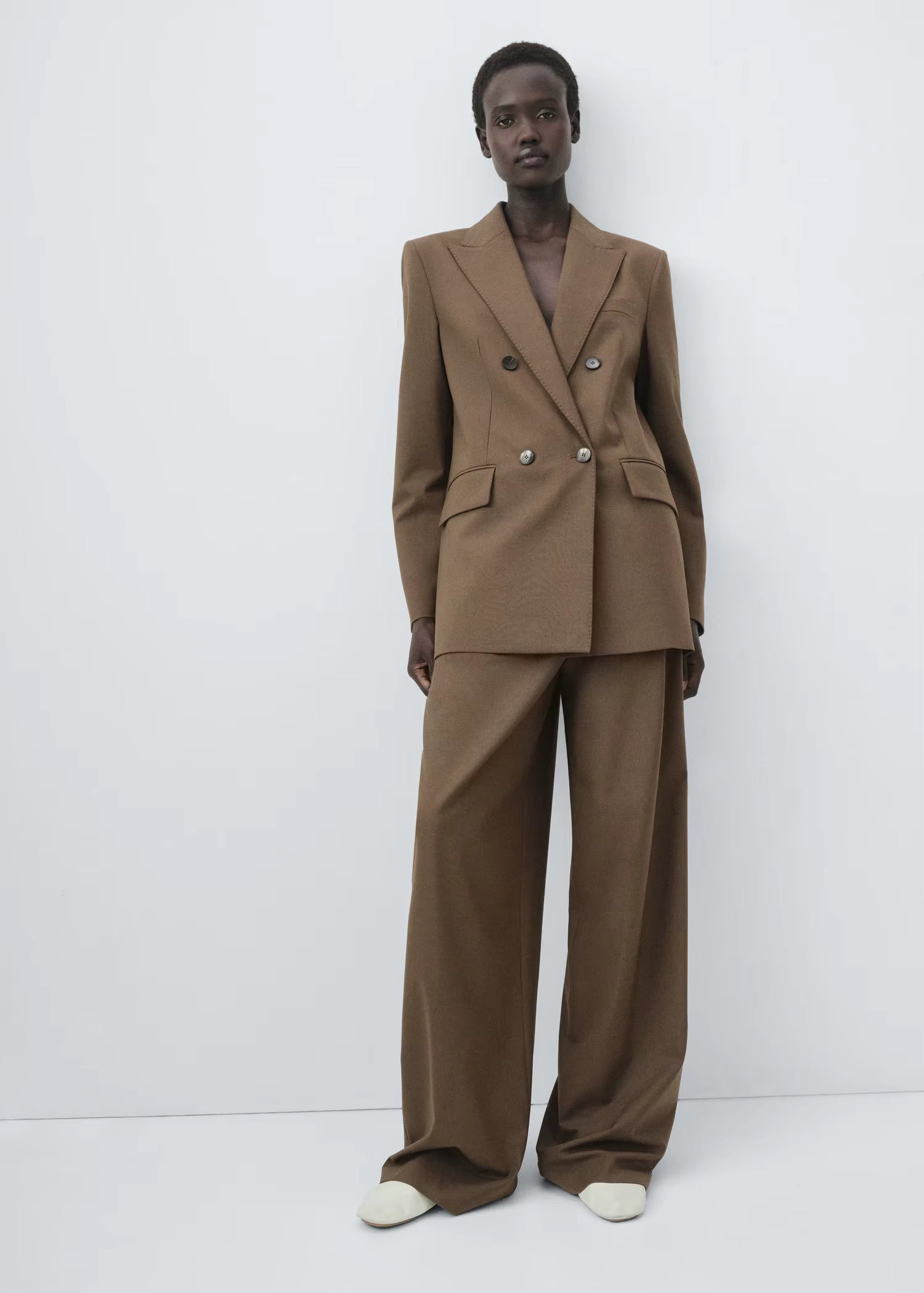 Structured women’s tailored jacket with a peak lapel shoulder design.