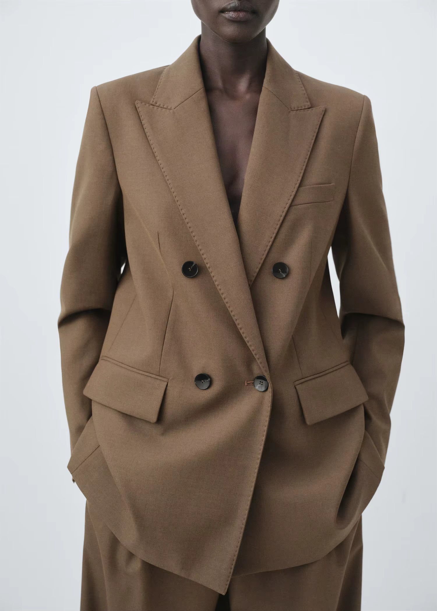 Structured women’s tailored jacket with a peak lapel shoulder design.