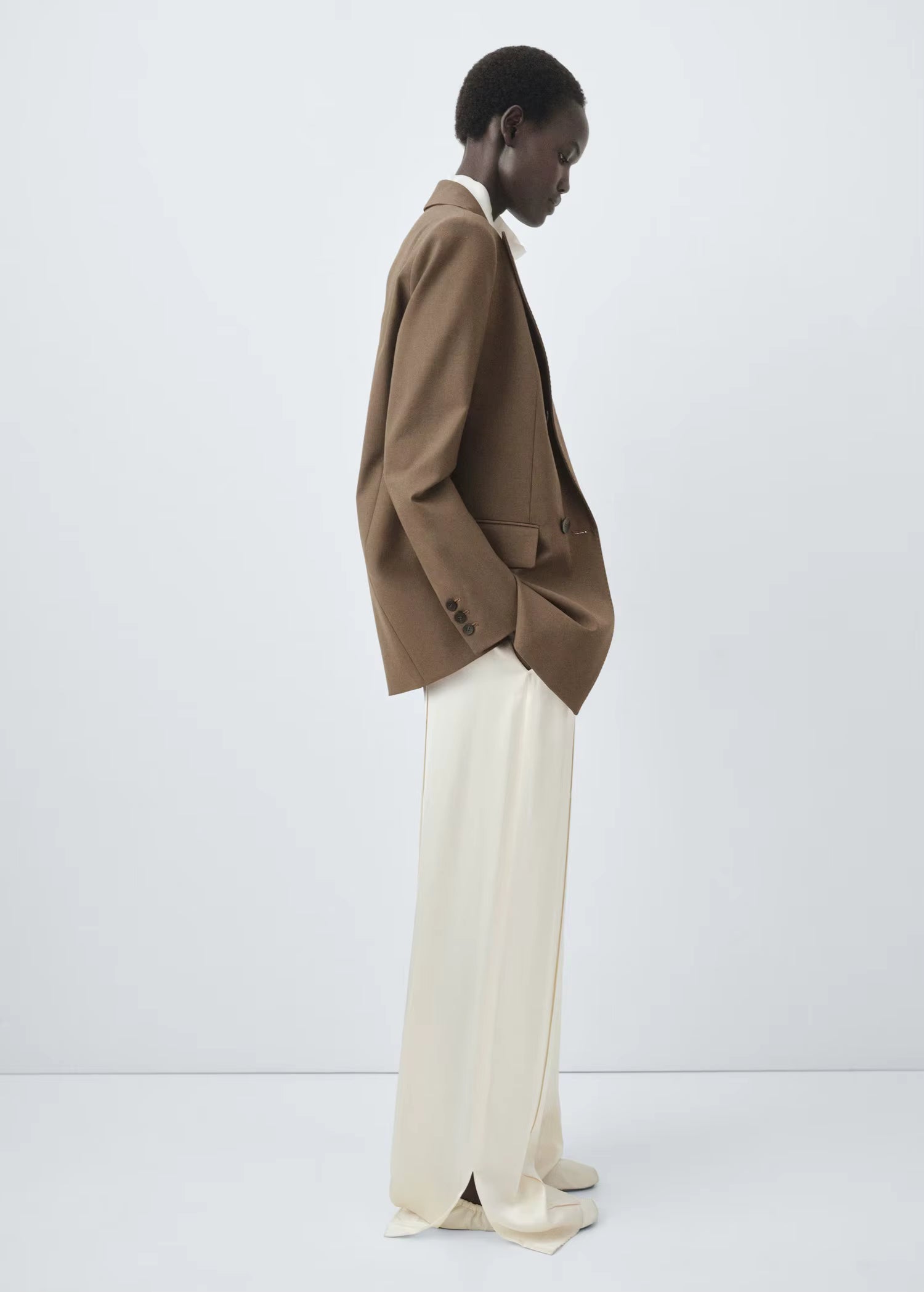 Structured women’s tailored jacket with a peak lapel shoulder design.